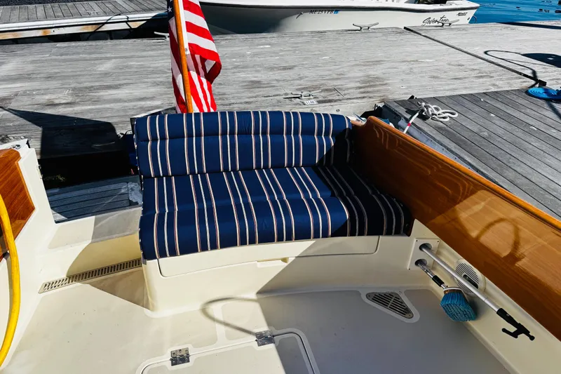 Maverick Yacht Photos Pics Hinckley Picnic Boat MKIII 2012 with striped seating and American flag at dock.