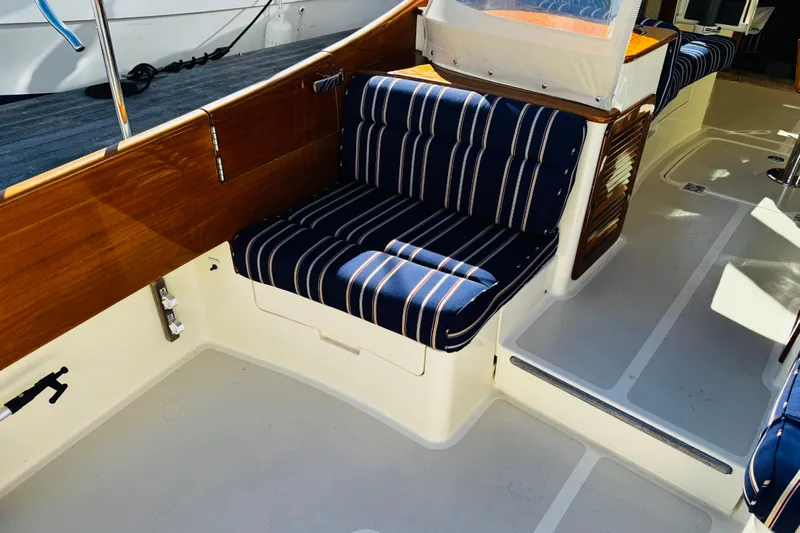 Maverick Yacht Photos Pics 2012 Hinckley Picnic Boat MKIII interior with striped seating and wooden accents.