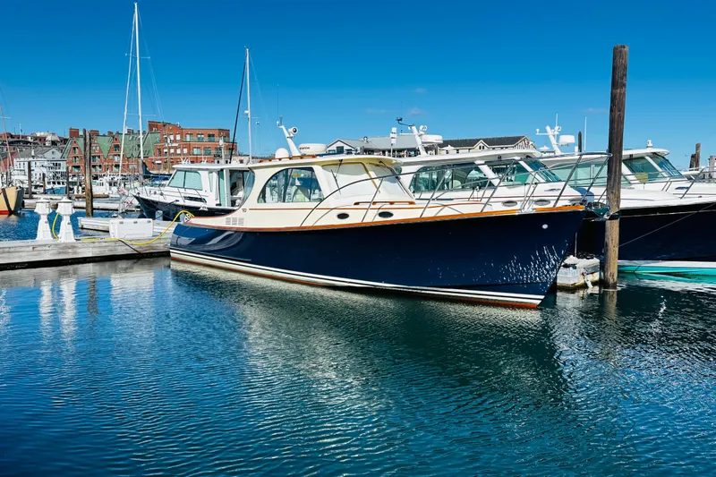 Maverick Yacht Photos Pics Hinckley Picnic Boat MKIII 2012 docked in a marina under clear blue skies.