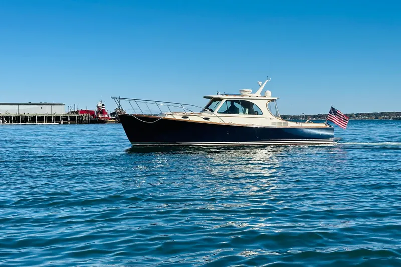 Maverick Yacht Photos Pics 2012 Hinckley Picnic Boat MKIII cruising on calm blue waters under clear sky.