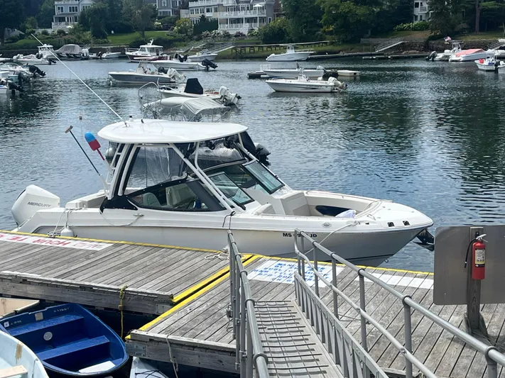  Yacht Photos Pics 2023 Boston Whaler 240 Vantage docked at a scenic marina.