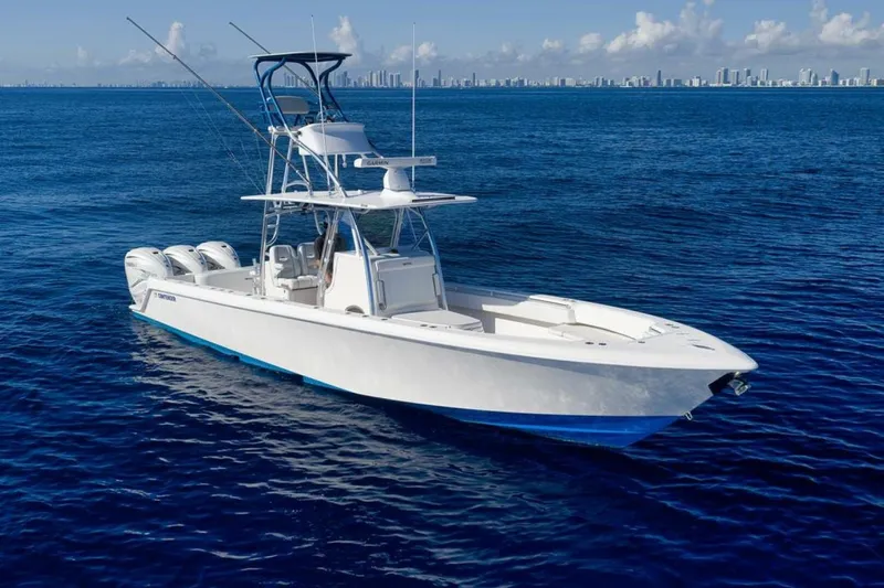 Top Shelf Too Yacht Photos Pics 2023 Contender 39 ST boat on open ocean with city skyline in background.