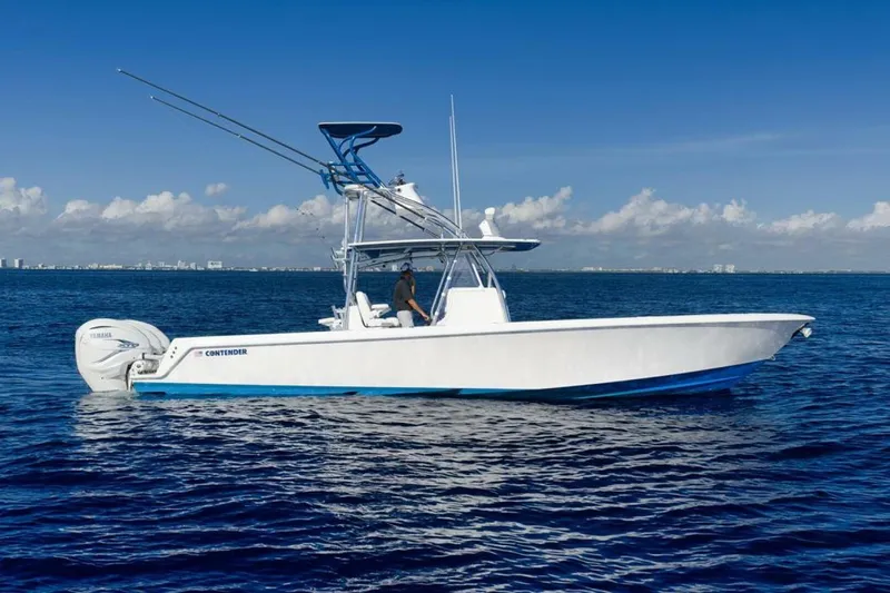 Top Shelf Too Yacht Photos Pics 2023 Contender 39 ST boat on open ocean under clear blue sky.