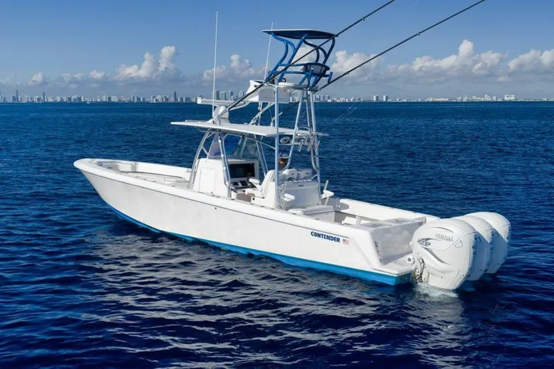 Top Shelf Too Yacht Photos Pics 2023 Contender 39 ST boat on open ocean with city skyline in background.