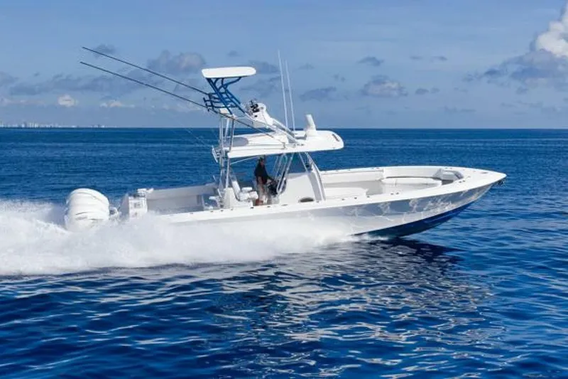 Top Shelf Too Yacht Photos Pics 2023 Contender 39 ST boat cruising on open ocean under clear blue sky.