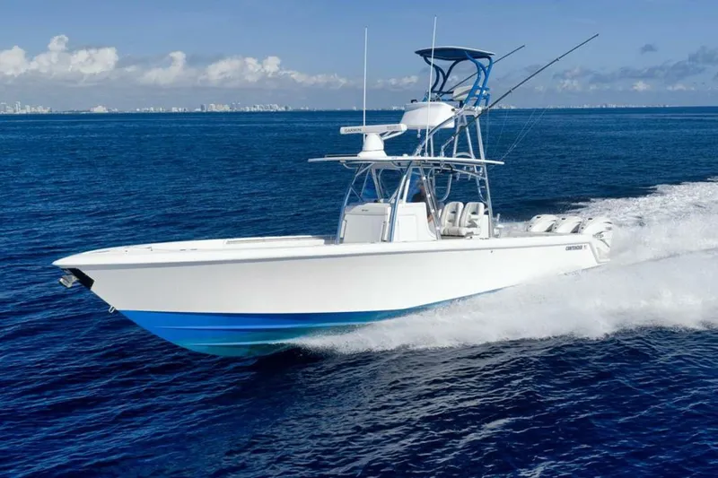 Top Shelf Too Yacht Photos Pics 2023 Contender 39 ST boat cruising on open blue ocean waters.