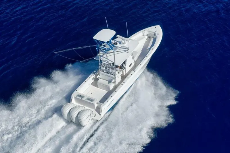 Top Shelf Too Yacht Photos Pics 2023 Contender 39 ST boat cruising on open blue water, aerial view.
