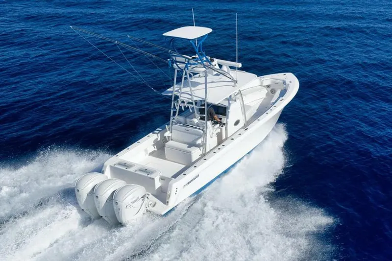 Top Shelf Too Yacht Photos Pics 2023 Contender 39 ST boat cruising on open blue ocean waters.