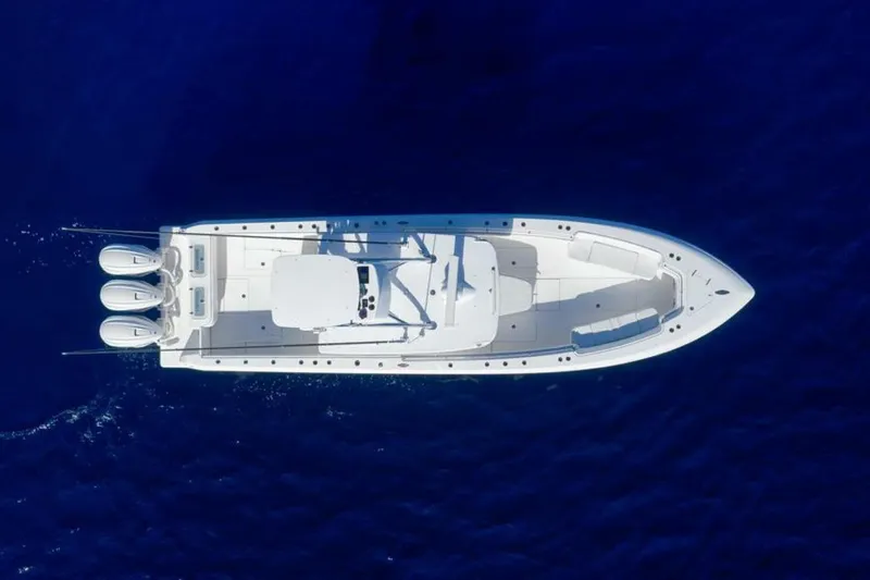 Top Shelf Too Yacht Photos Pics Aerial view of 2023 Contender 39 ST boat on deep blue water.