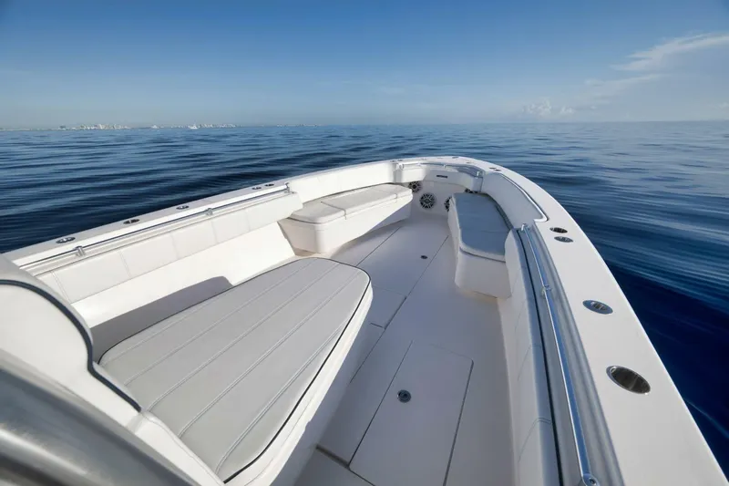 Top Shelf Too Yacht Photos Pics 2023 Contender 39 ST boat on calm ocean, showcasing spacious deck and seating.
