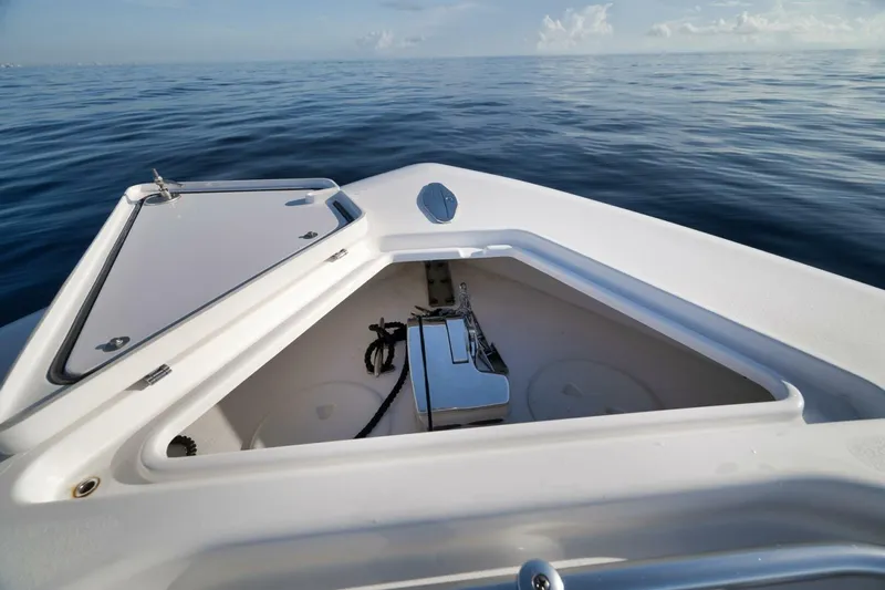 Top Shelf Too Yacht Photos Pics 2023 Contender 39 ST boat anchor compartment on calm ocean waters.