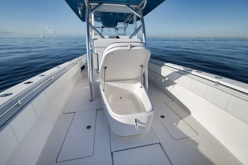 Top Shelf Too Yacht Photos Pics 2023 Contender 39 ST boat with open storage compartment on calm ocean.