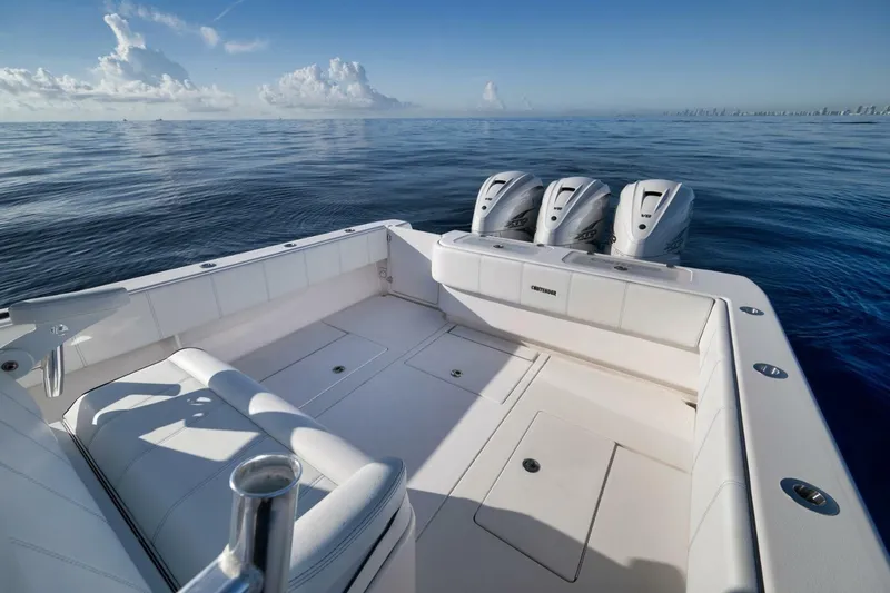 Top Shelf Too Yacht Photos Pics 2023 Contender 39 ST boat with triple engines on calm ocean waters.