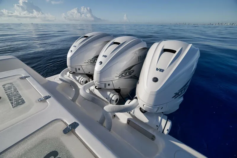 Top Shelf Too Yacht Photos Pics 2023 Contender 39 ST boat with triple Yamaha V8 outboard engines on calm ocean.