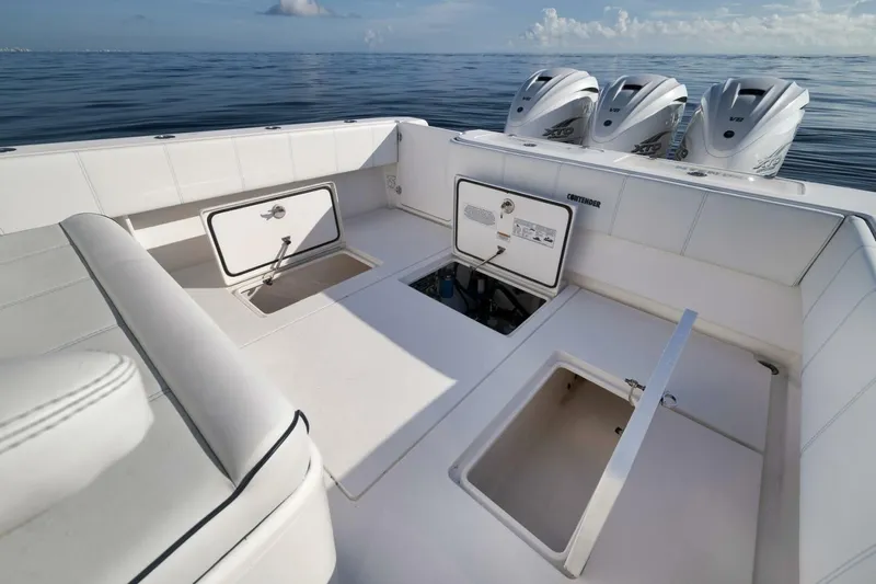 Top Shelf Too Yacht Photos Pics 2023 Contender 39 ST boat interior with open storage compartments and triple outboard engines.