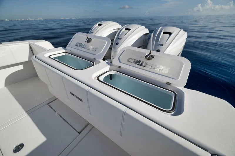 Top Shelf Too Yacht Photos Pics 2023 Contender 39 ST boat with open storage compartments and triple outboard engines.