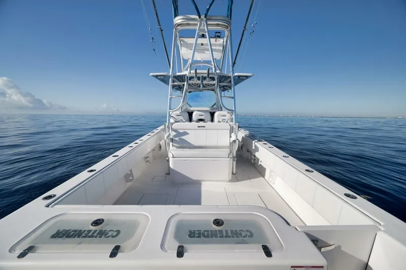 Top Shelf Too Yacht Photos Pics 2023 Contender 39 ST boat on calm ocean waters under clear blue sky.