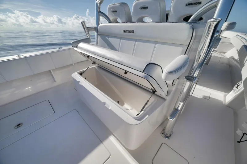 Top Shelf Too Yacht Photos Pics 2023 Contender 39 ST boat interior with open storage compartment, sleek design, and ocean backdrop.