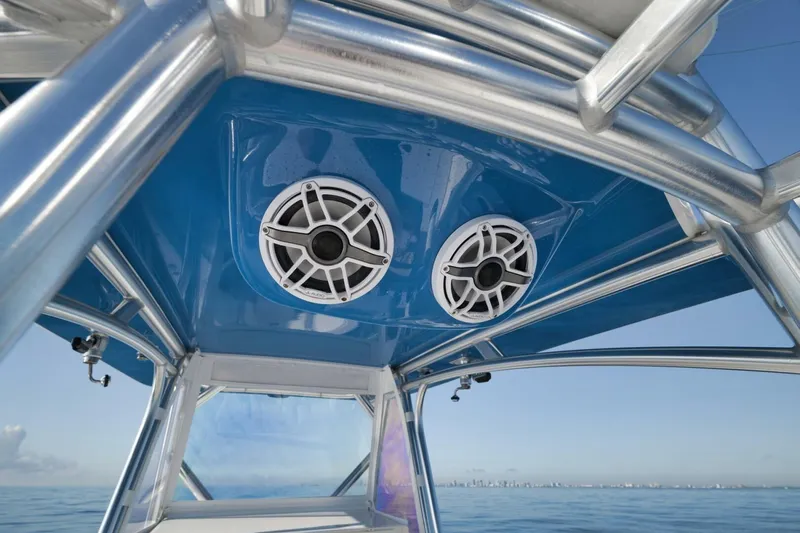 Top Shelf Too Yacht Photos Pics 2023 Contender 39 ST boat speakers on blue canopy, ocean view.