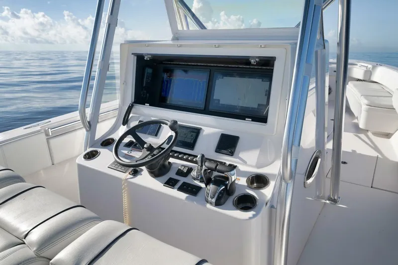 Top Shelf Too Yacht Photos Pics 2023 Contender 39 ST boat cockpit with modern controls and navigation screens.