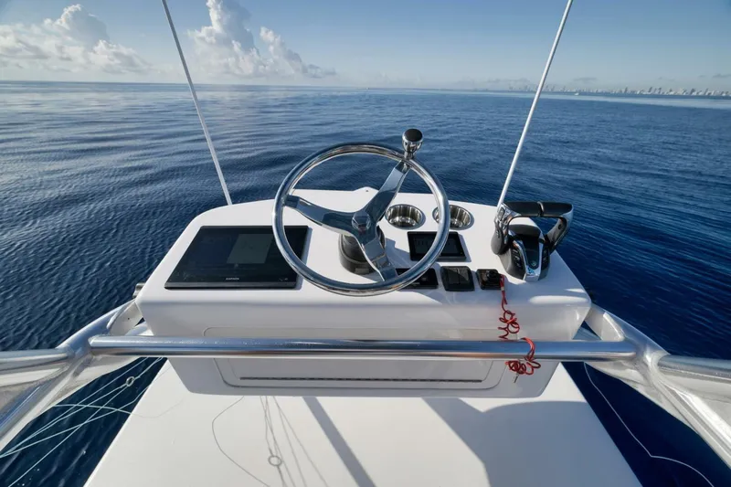 Top Shelf Too Yacht Photos Pics Helm of 2023 Contender 39 ST boat with ocean view and clear sky.
