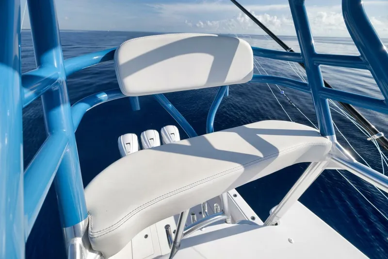 Top Shelf Too Yacht Photos Pics 2023 Contender 39 ST boat seat with blue frame on calm ocean.