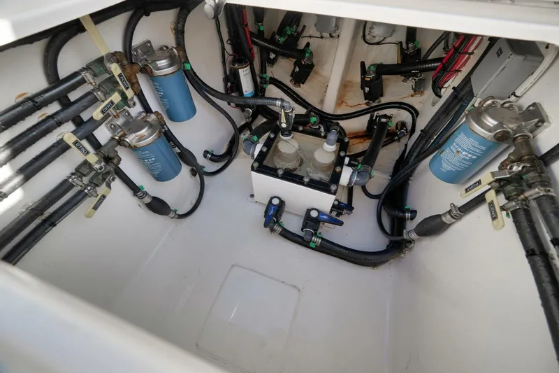 Top Shelf Too Yacht Photos Pics Engine compartment of 2023 Contender 39 ST boat, showcasing fuel filters and hoses.