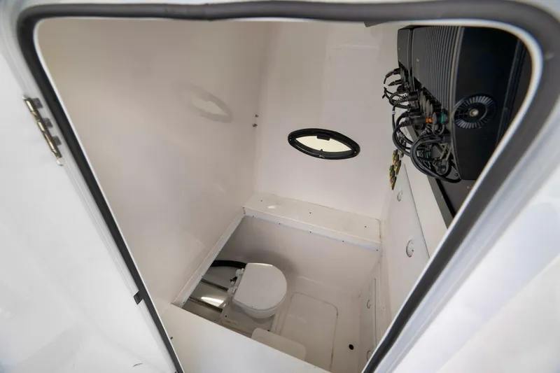 Top Shelf Too Yacht Photos Pics 2023 Contender 39 ST boat interior with compact bathroom and equipment panel.