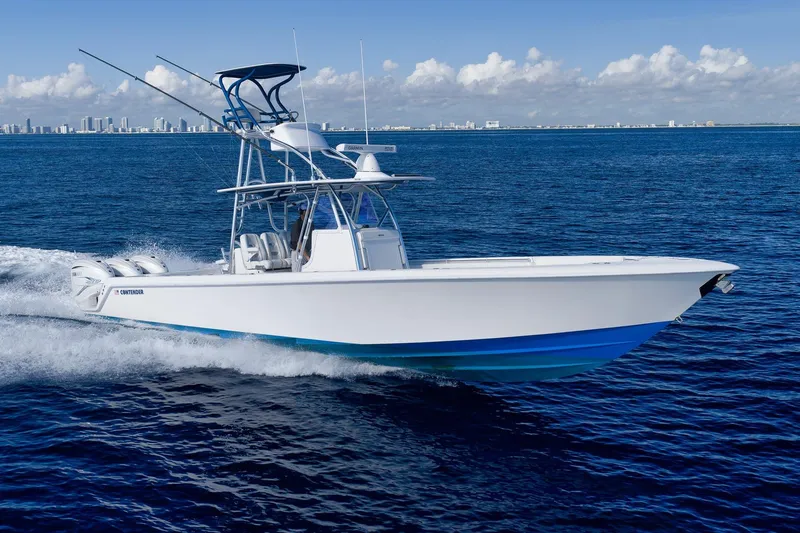 Top Shelf Too Yacht Photos Pics 2023 Contender 39 ST boat cruising on open ocean with city skyline in background.