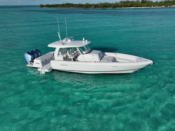  Yacht Photos Pics 2023 Intrepid 427 Nomad SE boat on clear turquoise water.