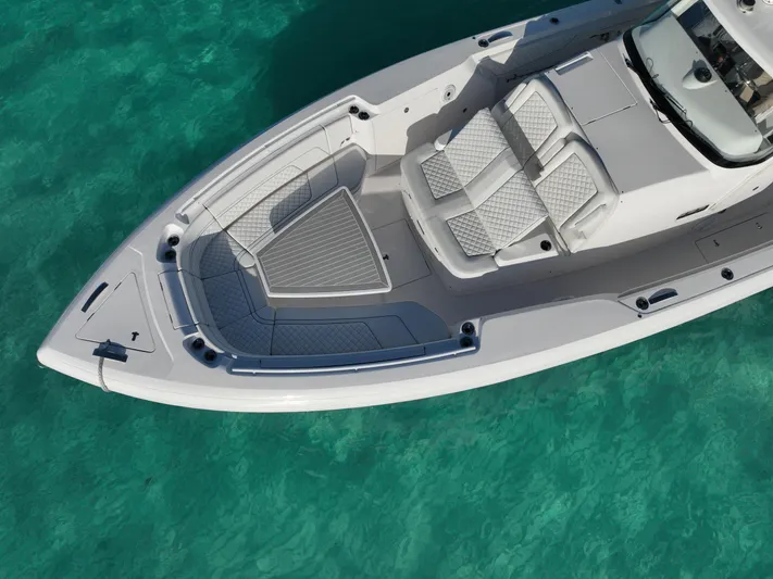  Yacht Photos Pics 2023 Intrepid 427 Nomad SE boat on clear turquoise water, aerial view.