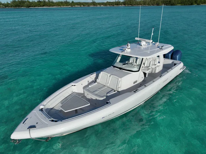  Yacht Photos Pics 2023 Intrepid 427 Nomad SE boat on clear turquoise water.