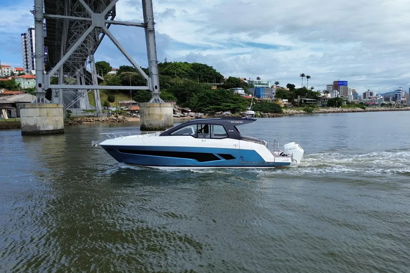  Yacht Photos Pics 2026 Schaefer 380 yacht cruising under a bridge on a scenic waterway.