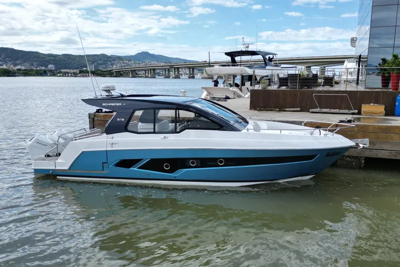  Yacht Photos Pics 2026 Schaefer 380 yacht docked by a waterfront, showcasing sleek design and modern features.