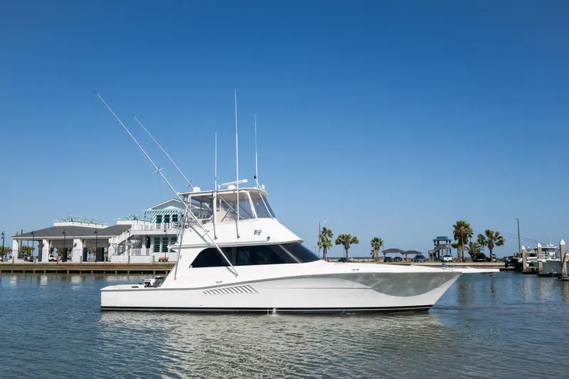  Yacht Photos Pics 1999 Viking 47 Convertible yacht on calm water with clear blue sky.