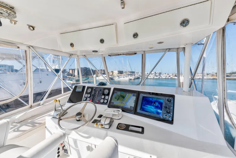  Yacht Photos Pics Interior view of 1999 Viking 47 Convertible yacht cockpit with navigation equipment.