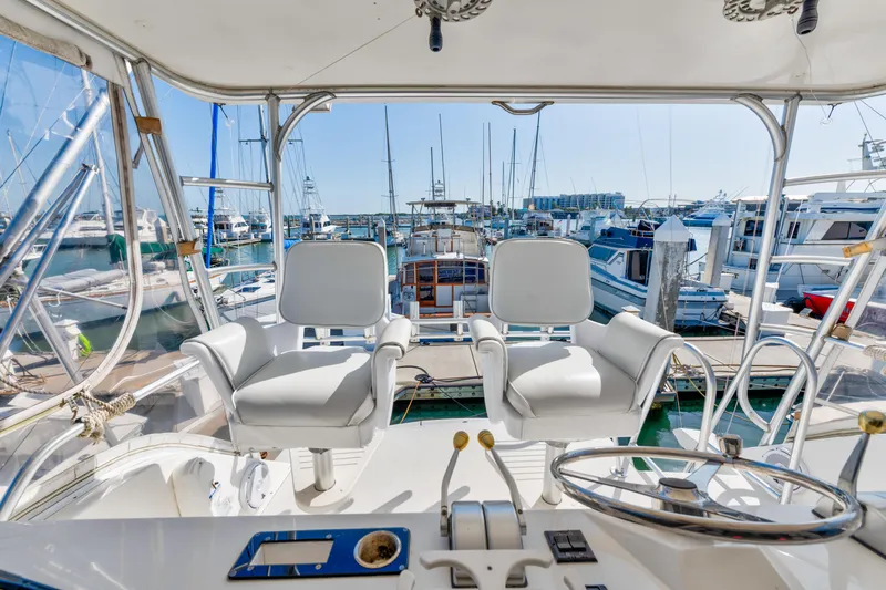  Yacht Photos Pics Cockpit view of 1999 Viking 47 Convertible yacht docked at marina.