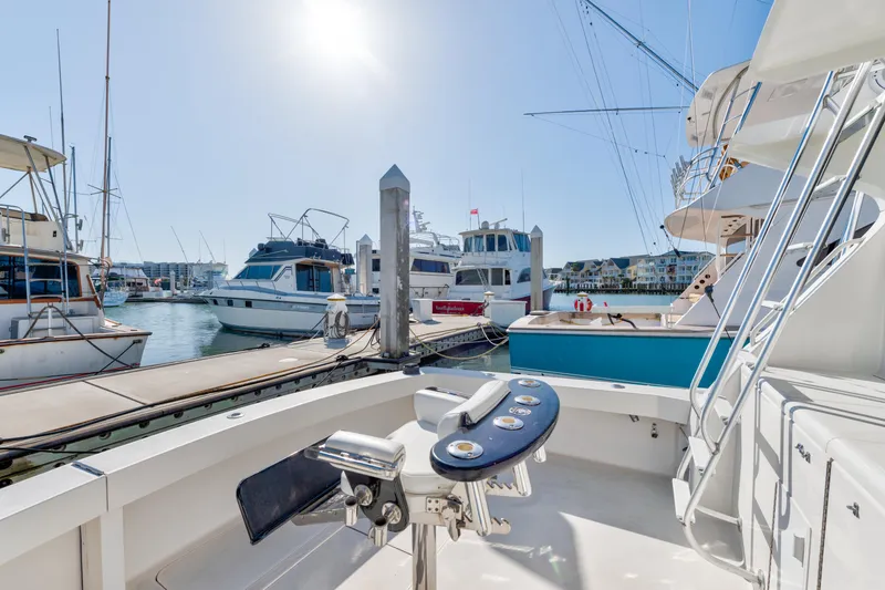  Yacht Photos Pics 1999 Viking 47 Convertible yacht docked at marina under bright sunlight.