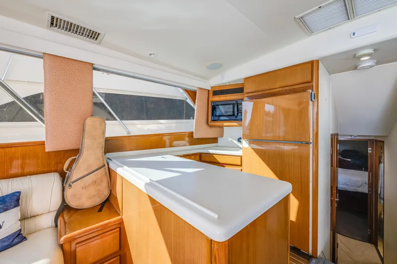  Yacht Photos Pics Interior of 1999 Viking 47 Convertible yacht with kitchen and guitar case.