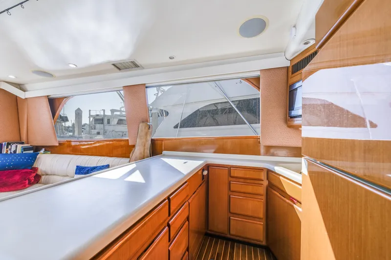  Yacht Photos Pics Interior of 1999 Viking 47 Convertible yacht with wooden cabinetry and large windows.