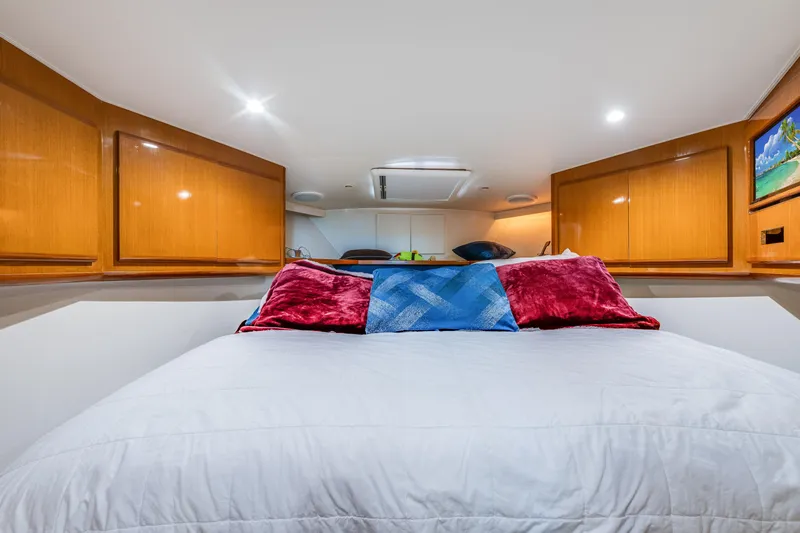  Yacht Photos Pics Luxurious bedroom interior of 1999 Viking 47 Convertible yacht with plush bedding.
