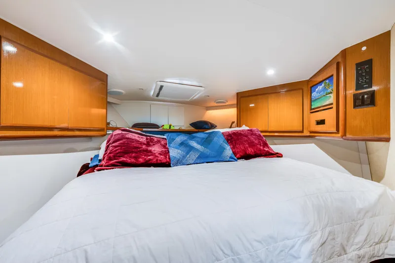  Yacht Photos Pics Luxurious cabin interior of 1999 Viking 47 Convertible yacht with cozy bedding.