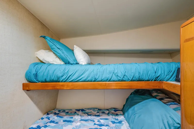  Yacht Photos Pics Bunk beds with blue bedding in a 1999 Viking 47 Convertible yacht cabin.