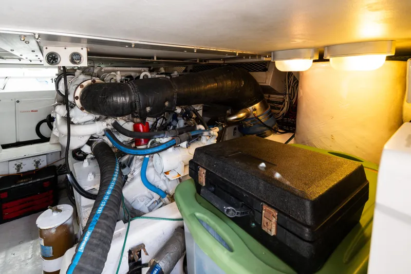  Yacht Photos Pics Engine room of a 1999 Viking 47 Convertible yacht, featuring mechanical components and storage.