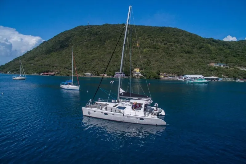 Moonstruck Yacht Photos Pics 2018 Voyage Yachts VOYAGE 480 sailing near lush green island coast.