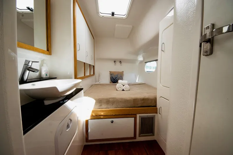 Moonstruck Yacht Photos Pics Luxurious cabin interior of 2018 Voyage Yachts VOYAGE 480, featuring a cozy bed and modern amenities.