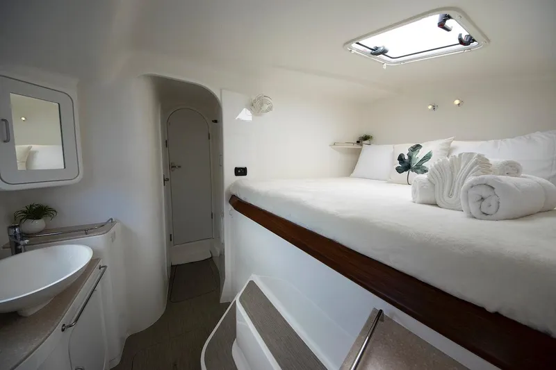 Moonstruck Yacht Photos Pics Luxurious cabin interior of 2018 Voyage Yachts VOYAGE 480 with cozy bed and modern amenities.