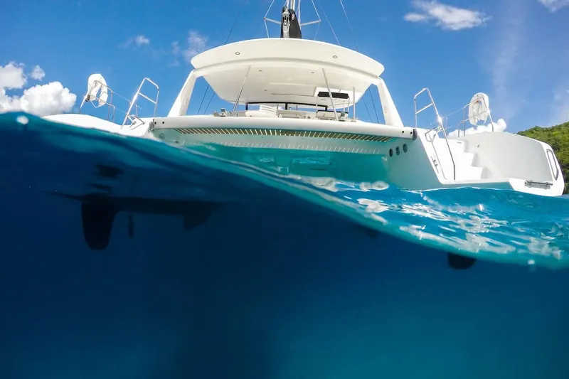 Moonstruck Yacht Photos Pics 2018 Voyage Yachts VOYAGE 480 catamaran on clear blue water, viewed from below.