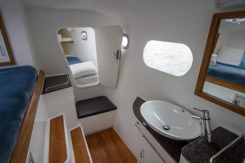 Moonstruck Yacht Photos Pics Interior of 2018 Voyage Yachts VOYAGE 480, featuring a modern bathroom and cozy sleeping area.