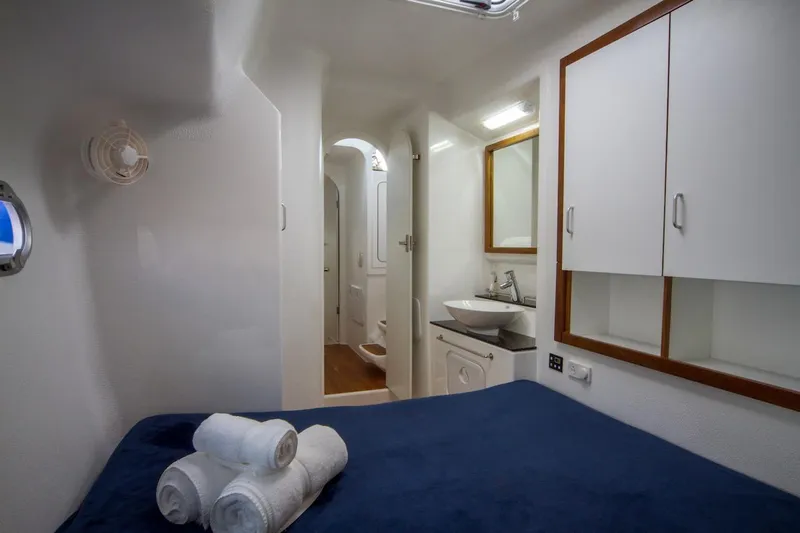 Moonstruck Yacht Photos Pics Luxurious cabin interior of 2018 Voyage Yachts VOYAGE 480 with bed, sink, and storage.